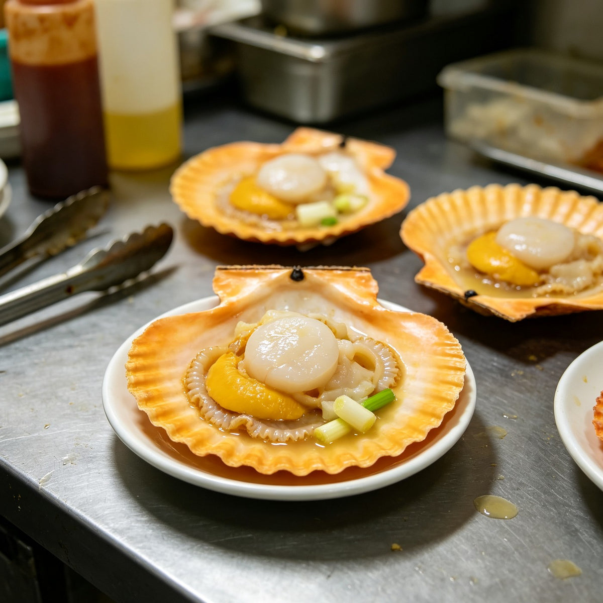 Fresh scallops in their orange shells with roe attached