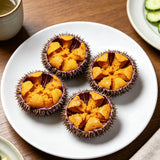 Opened sea urchins showing bright orange roe